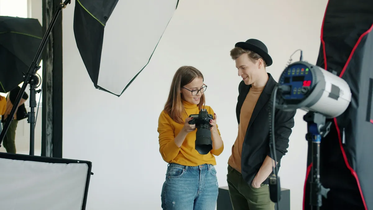 Mia, second shooter, reviewing frames with a client